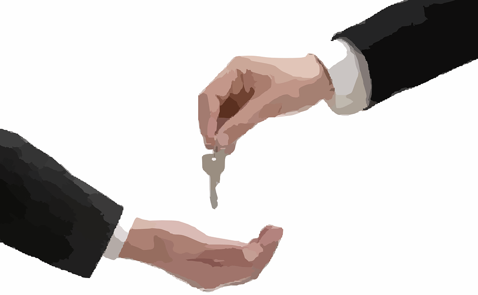 A person hand over the key to another person.